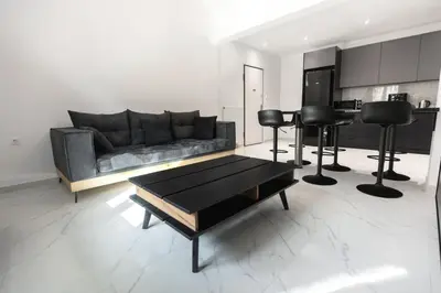 a living room with a couch and a table at Flouris Apartments in Athens