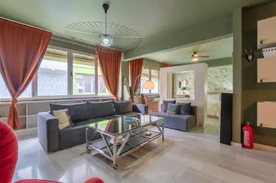 a living room with a couch and a glass table at Athens' Pearl in Athens