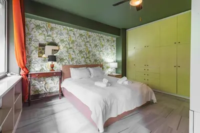 a bedroom with a bed with towels on it at Athens' Pearl in Athens