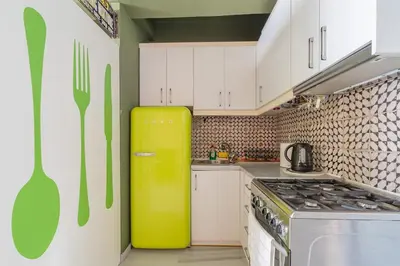a kitchen with a yellow refrigerator and white cabinets at Athens' Pearl in Athens