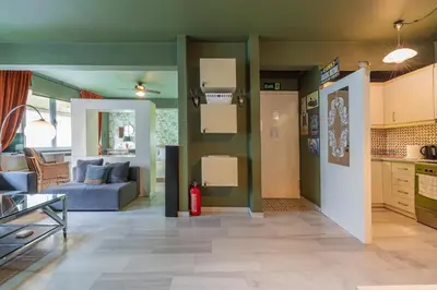a living room with a couch and a kitchen at Athens' Pearl in Athens
