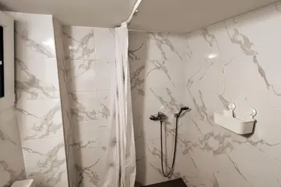a bathroom with a shower and a toilet at Quiet apartment in the centre of Athens in Athens