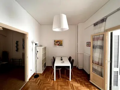a dining room with a white table and chairs at Quiet apartment in the centre of Athens in Athens