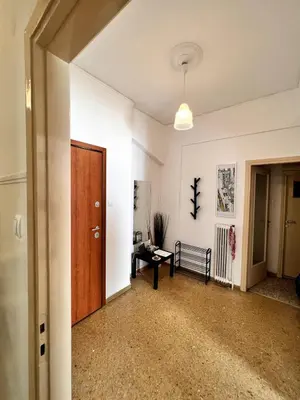 an empty room with a door and a bench at Quiet apartment in the centre of Athens in Athens