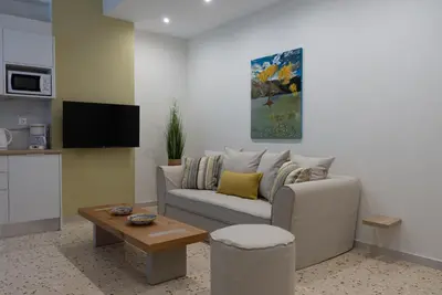 a living room with a couch and a table at Athens at a Glance - Luxury Apartments in Athens