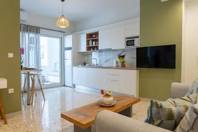 a living room with a couch and a table at Athens at a Glance - Luxury Apartments in Athens