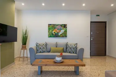 a living room with a couch and a table at Athens at a Glance - Luxury Apartments in Athens