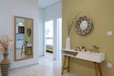 a room with a mirror and a table with a mirror at Athens at a Glance - Luxury Apartments in Athens