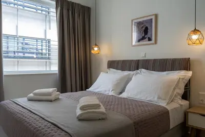 a bedroom with a bed with two towels on it at Athens at a Glance - Luxury Apartments in Athens