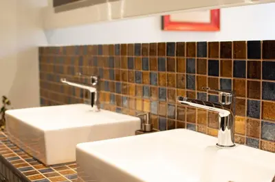 two sinks in a bathroom with two faucets at Georgette's Charming Studio near Metro by MPS in Athens