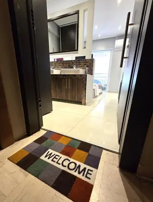 a welcome mat on the floor of a bathroom at Georgette's Charming Studio near Metro by MPS in Athens