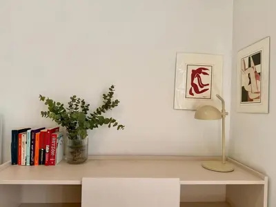 a shelf with books and a lamp and a potted plant at Quaint & Central Acropolis apartment in Athens