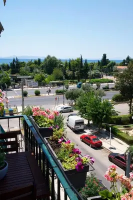 a view of a parking lot with flowers on a balcony at Delightful Seaside & Romantic in Athens