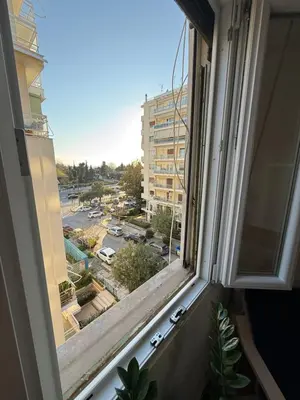 a window with a view of a city at Delightful Seaside & Romantic in Athens