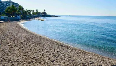 a beach with footprints in the sand and the water at Delightful Seaside & Romantic in Athens