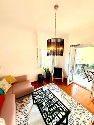 a living room with a couch and a chandelier at Delightful Seaside & Romantic in Athens