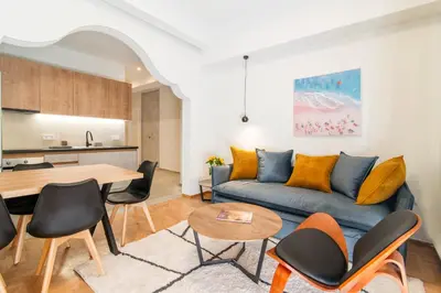 a living room with a couch and a table at A42 Renovated in 25 8 minutes to Acropolis Museum Heart of Koukaki in Athens