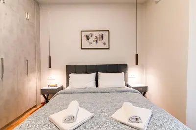 a bedroom with a bed with two towels on it at A42 Renovated in 25 8 minutes to Acropolis Museum Heart of Koukaki in Athens