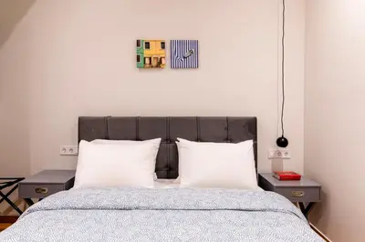 a bedroom with a bed with two white pillows at A42 Renovated in 25 8 minutes to Acropolis Museum Heart of Koukaki in Athens