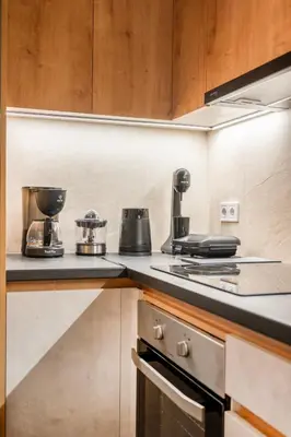 a kitchen with a stove and a counter top at A42 Renovated in 25 8 minutes to Acropolis Museum Heart of Koukaki in Athens
