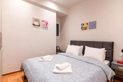 a bedroom with a bed with two towels on it at A42 Renovated in 25 8 minutes to Acropolis Museum Heart of Koukaki in Athens
