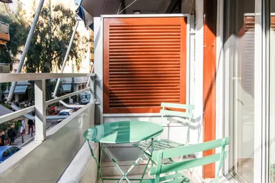 a table and two chairs on a balcony at A42 Renovated in 25 8 minutes to Acropolis Museum Heart of Koukaki in Athens