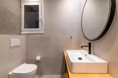 a bathroom with a sink and a toilet and a mirror at A42 Renovated in 25 8 minutes to Acropolis Museum Heart of Koukaki in Athens