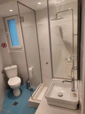 a bathroom with a shower and a toilet and a sink at Acropolis Luxe Stay in Athens