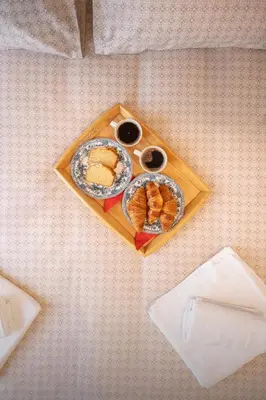 a tray with two plates of food on a table at Acropolis Luxe Stay in Athens