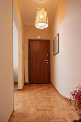a hallway with a door and a wooden floor at Acropolis Luxe Stay in Athens