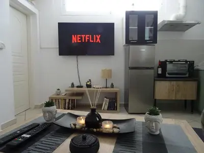 a kitchen with a refrigerator and a table with candles at Secret Nest in Athens