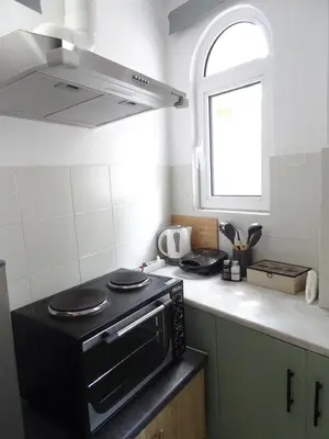 a kitchen with a black stove and a window at Secret Nest in Athens