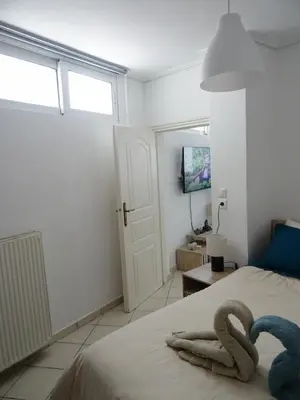 a bedroom with a bed with two swans on it at Secret Nest in Athens