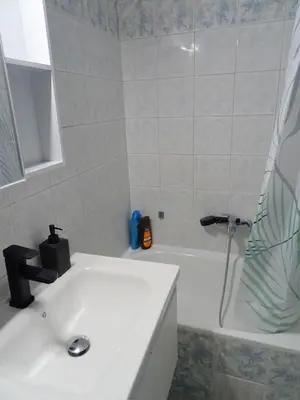 a bathroom with a sink and a bath tub at Secret Nest in Athens
