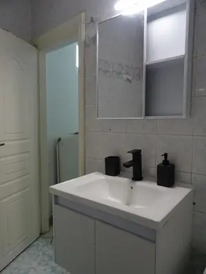 a bathroom with a white sink and a mirror at Secret Nest in Athens