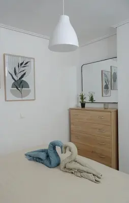 a bedroom with two towel swans on a bed at Secret Nest in Athens