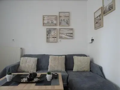 a living room with a blue couch and a table at Secret Nest in Athens