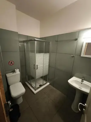a bathroom with a shower and a toilet and a sink at Liberal Mini Rooms in Athens