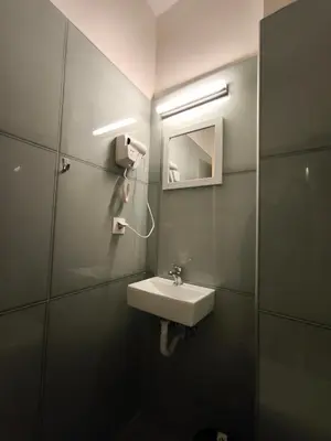 a bathroom with a sink and a mirror at Liberal Mini Rooms in Athens