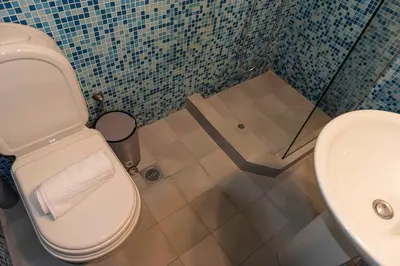 a bathroom with a toilet and a sink at Modern Blue Retreat in Athens