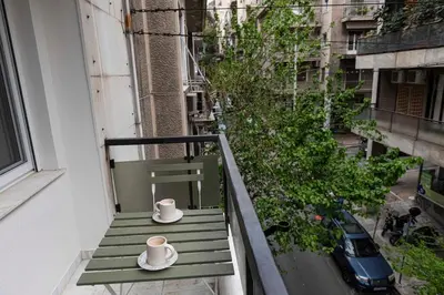 a balcony with a green bench and two hats at Modern Blue Retreat in Athens