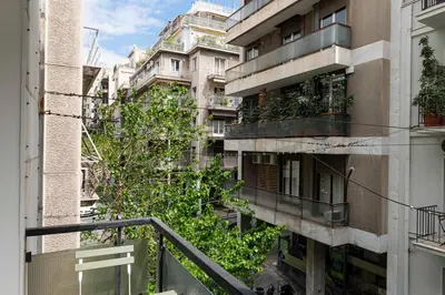 an apartment building with plants on the side of it at Modern Blue Retreat in Athens