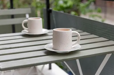 two coffee cups sitting on a wooden table at Modern Blue Retreat in Athens