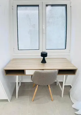 a desk with a chair in front of two windows at Central Apartment At Pangrati in Athens