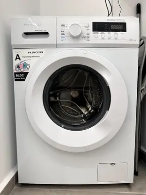a white washing machine in a room at Central Apartment At Pangrati in Athens