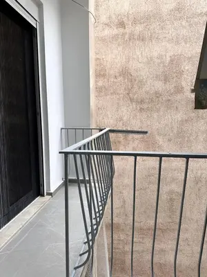 a metal railing in front of a building with a door at Central Apartment At Pangrati in Athens