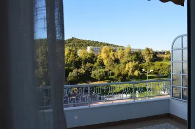 a balcony with a view of trees and a mountain at Athens Luxury Apartments Rodos in Athens