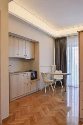 a kitchen and dining room with a table and chairs at Athens Luxury Apartments Rodos in Athens