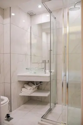 a bathroom with a glass shower and a sink at Athens Luxury Apartments Rodos in Athens