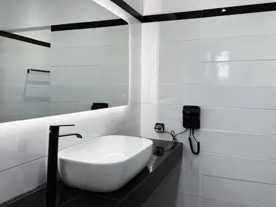 a white sink in a bathroom with a mirror at Beachfront 3bedroom apartment in Porto Rafti